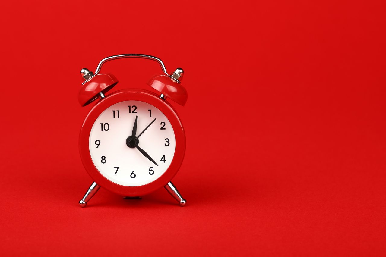 a red clock on the red background