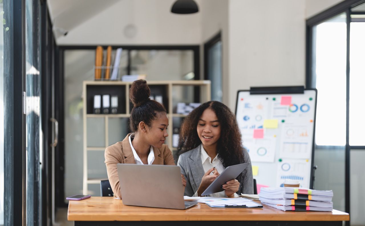 two business people discussing their notes about business